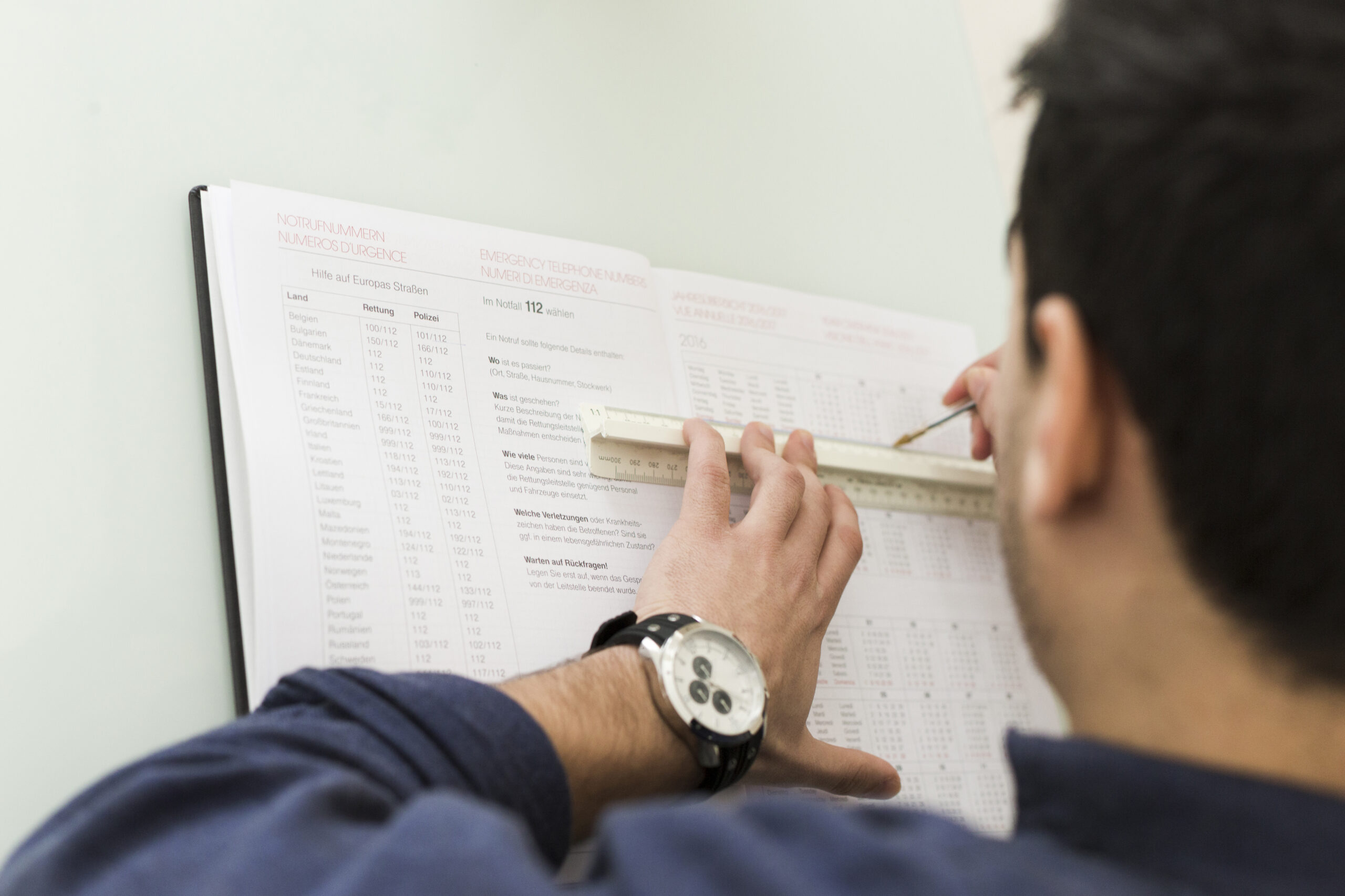 crop-man-underlining-data-notebook