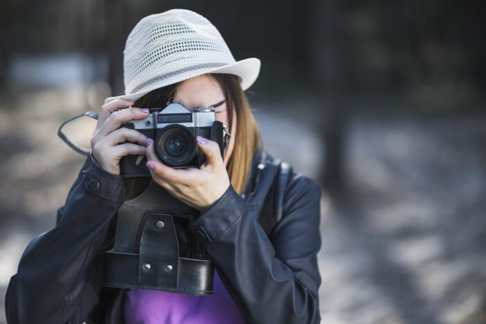 woman-white-hat-taking-pictures